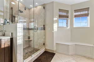 Bathroom featuring tile patterned floors, an enclosed shower, and vanity