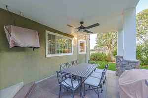 View of patio featuring ceiling fan and grilling area with TV for viewing and entertainment