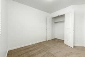 Unfurnished bedroom 2 with carpet floors and a closet