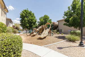 View of playground with trees, bushes, and xeriscape