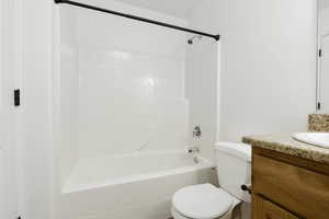 Full bathroom 2 featuring toilet, shower / bathing tub combination, and granite counter top vanity with light brown cabinet