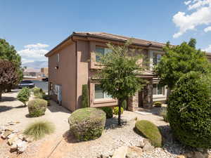 Exterior front of townhome with trees, bushes, with xeriscape