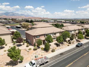 Drone / aerial view of townhomes featuring a mountain view in background