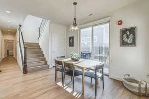 Dining space with light hardwood / wood-style flooring