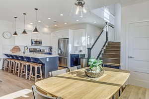 Dining area featuring sink and light hardwood / wood-style flooring