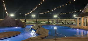 Pool at twilight with a patio