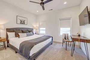 Bedroom featuring light colored carpet and ceiling fan