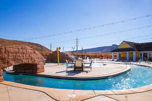 View of swimming pool with a mountain view, a patio, and pool water feature