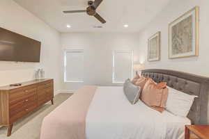 Carpeted bedroom with ceiling fan