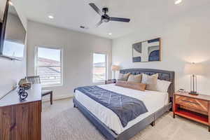 Bedroom featuring ceiling fan and light colored carpet