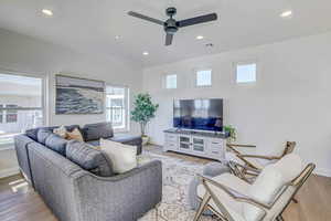 Living room featuring hardwood / wood-style flooring and ceiling fan