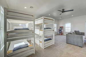 Bedroom featuring ceiling fan and carpet