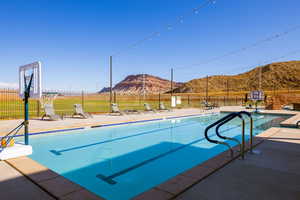 View of pool with a mountain view and a patio