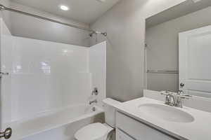 Full bathroom featuring shower / bathtub combination, toilet, and vanity