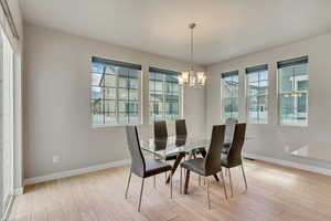 Dining room featuring a chandelier and light wood-type flooring