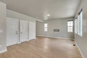 Unfurnished bedroom with light wood-type flooring and multiple closets