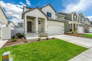 View of front of home with a garage and a front yard