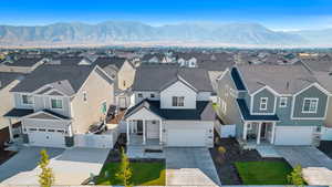 View of front of home with a mountain view and a garage