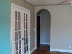 Unfurnished room featuring ceiling fan, french doors, and dark hardwood / wood-style floors