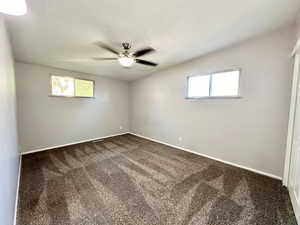 Bedroom.  Closet.  Windows.  Light grey walls.