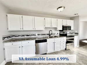 White cabinets, stainless steel appliances, granite counter tops, VA Assumable Loan