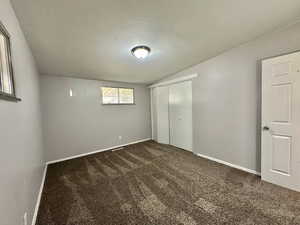 Second bedroom.  Carpet.  Windows.  Light grey walls.