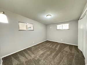 Second bedroom.  Carpet.  Windows.  Light grey walls.