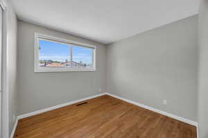 Unfurnished room featuring hardwood / wood-style floors