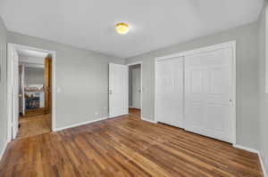 Unfurnished bedroom featuring a closet and wood-type flooring