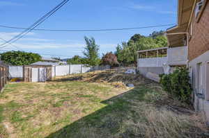 View of yard with a storage unit