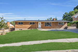 Ranch-style house with a digitally imposed front lawn. Driveways on both sides