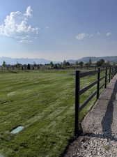 View of gate with a rural view and a yard