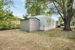 View of outdoor structure featuring a yard