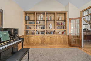 Sitting room with light hardwood / wood-style flooring and vaulted ceiling