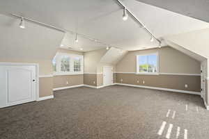 Bonus room featuring carpet floors and vaulted ceiling