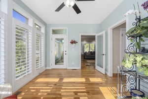 Entryway with ceiling fan and light hardwood / wood-style flooring