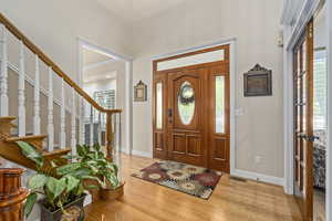 Foyer with light wood-type flooring and ornamental molding