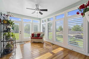 Sunroom featuring ceiling fan and a healthy amount of sunlight