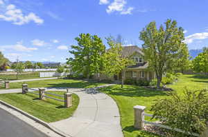 View of property's community with a lawn