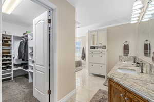 Bathroom with tile patterned floors and vanity