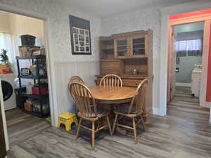 Dining space featuring hardwood / wood-style flooring, washer / dryer, and ornamental molding