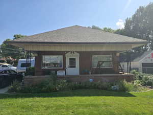 Back of house featuring a yard