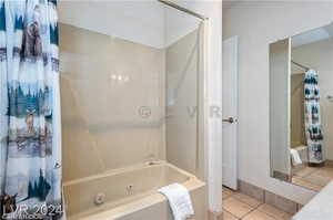 Bathroom with shower / bath combination with curtain and tile patterned flooring