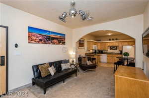 Tiled living room featuring a textured ceiling and sink