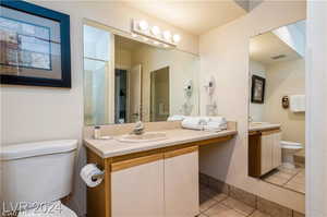 Bathroom featuring tile patterned flooring, toilet, and vanity