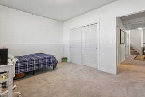 Bedroom featuring a closet and light carpet