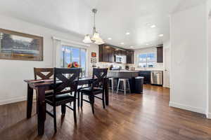 Dining space with dark hardwood / wood-style flooring