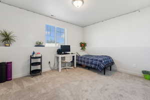 Bedroom featuring light colored carpet