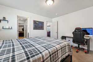 Carpeted bedroom with a closet and a spacious closet