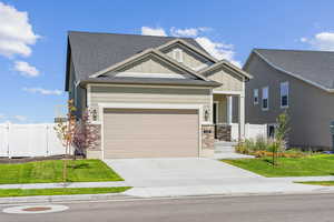 Craftsman-style house with a garage and a front yard